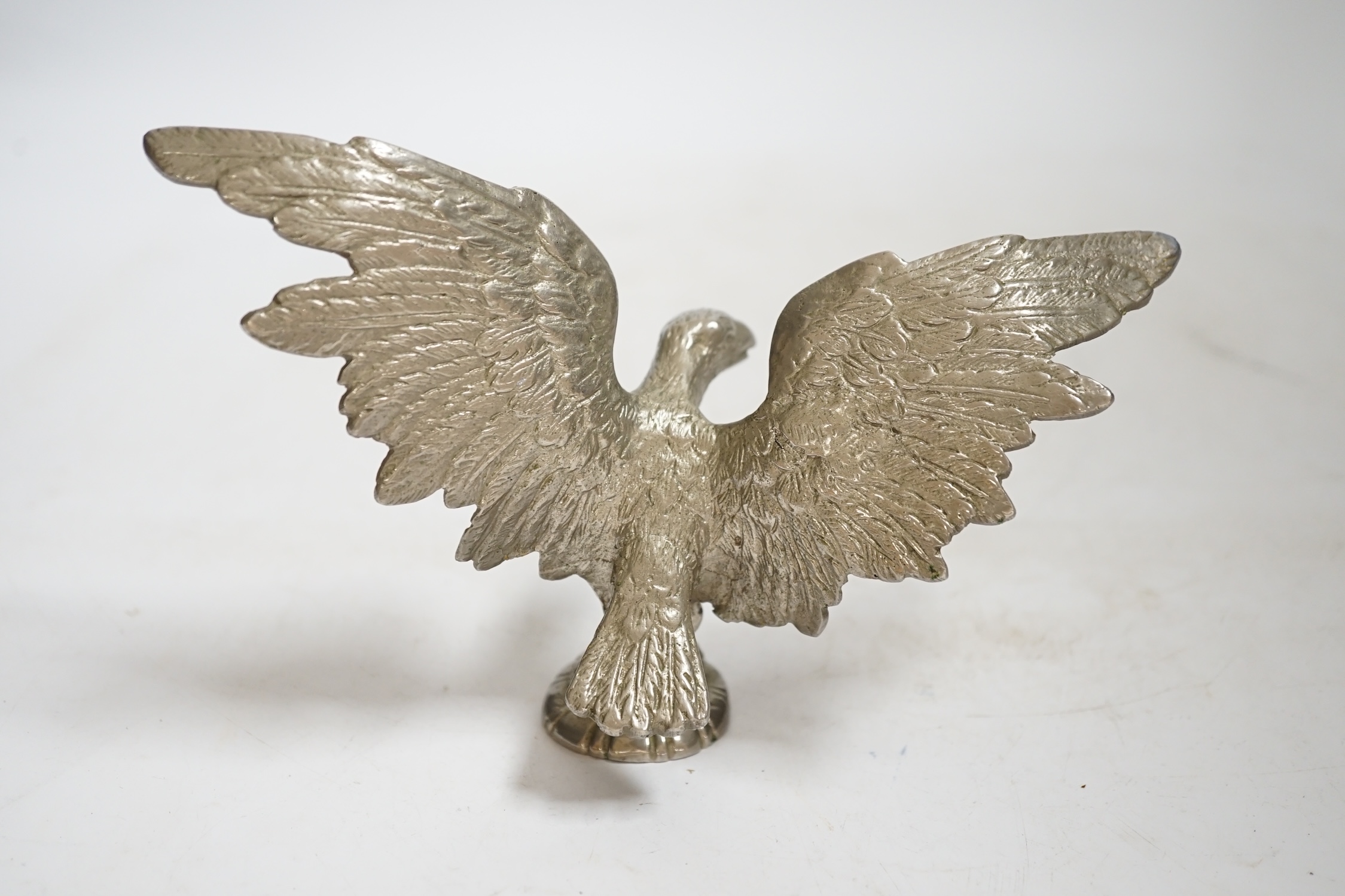 A mid 20th century chromed metal Eagle car mascot, 18cm wide. Condition - fair